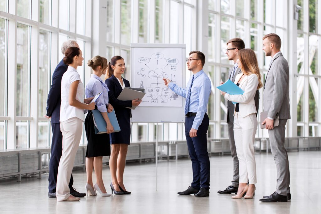 business team with scheme on flip chart at office